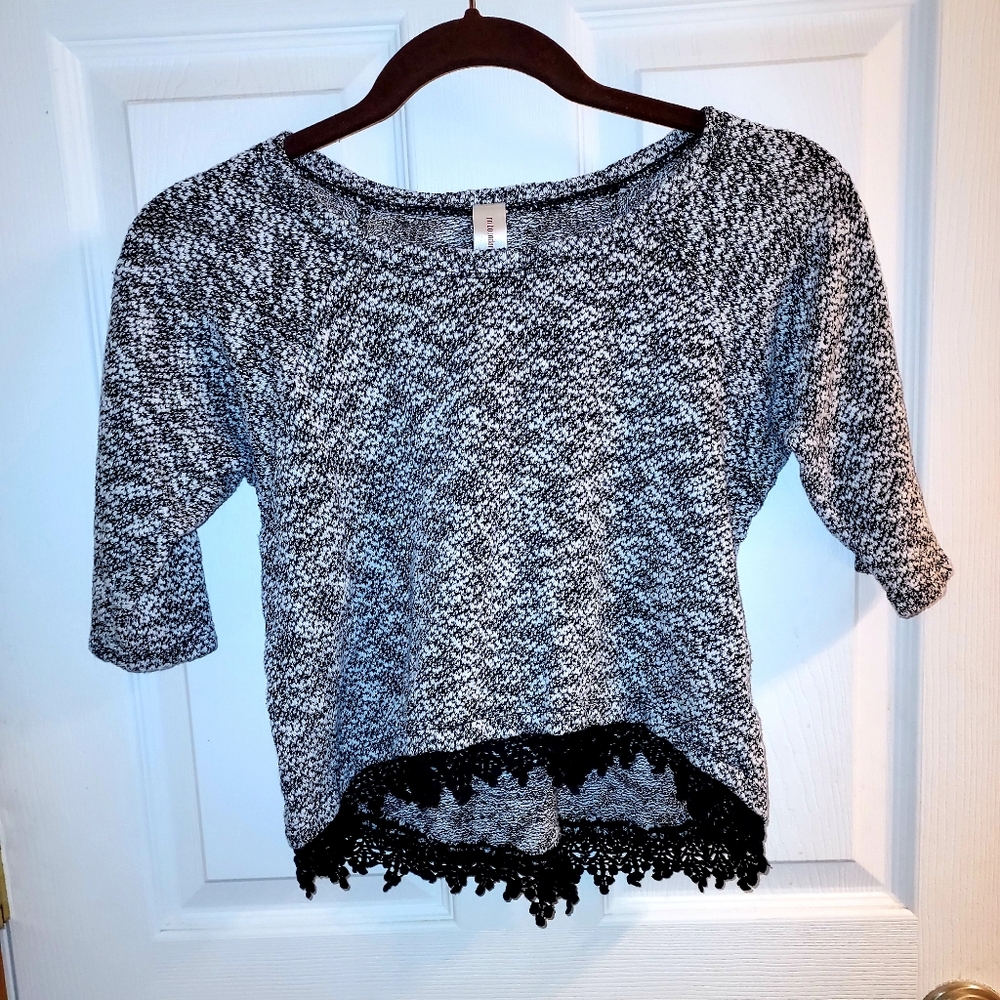 A gray and white t-shirt, size medium